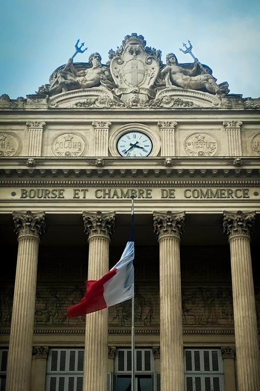 Bourse et Chambre de Commerce building facade with French flag