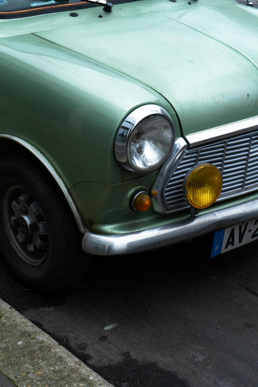 Vintage green car with French license plate parked on a street